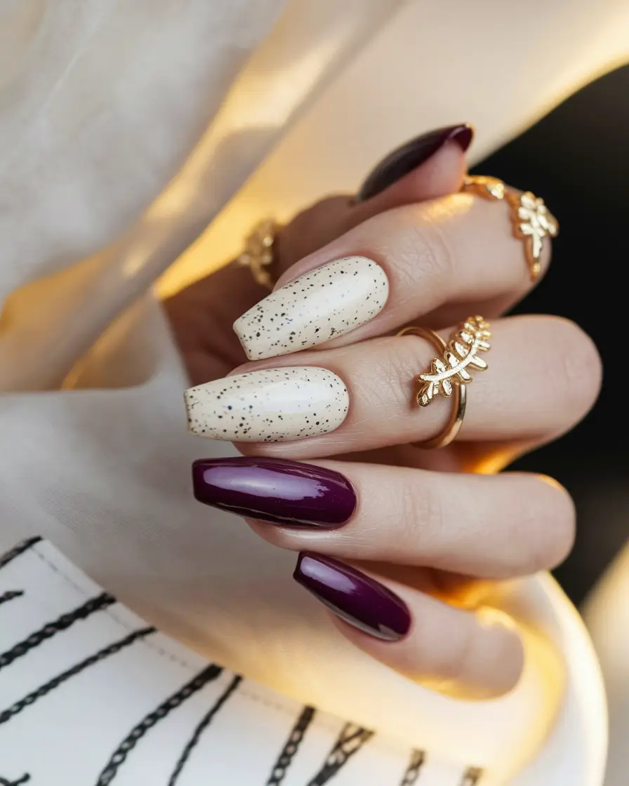 autumn nails designs 2025 Rich Plum and Vanilla Speckled Elegance